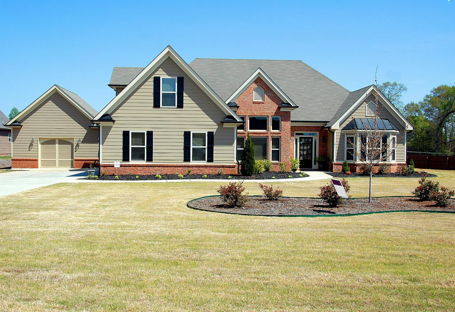 Classic residential property exterior with manicured landscaping under a clear sky